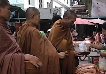 Practicing generosity creates positive karma. Here, a kind lay-Buddhist gives alms to three monks who, like the Buddha, eat only before noon and only from food given to them. Merit for good deeds is an intuitive concept in karma.