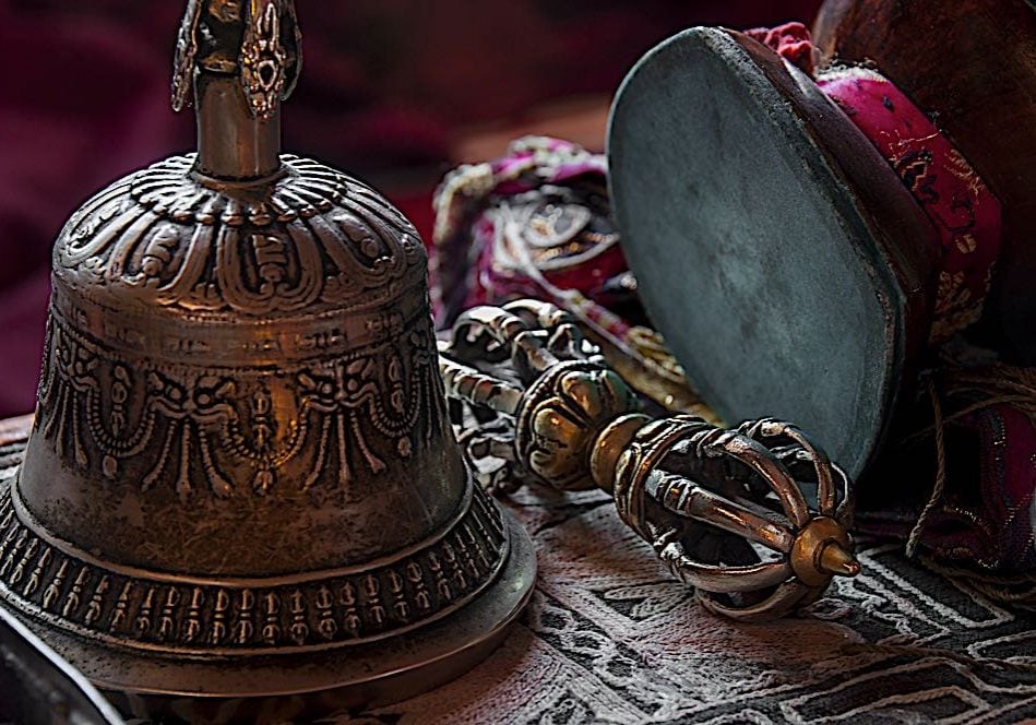 Bell, Vajra and Damaru drum are ubiquitous in Vajrayana Buddhism. The bell and Vajra are always together, and when not in use should be side-by-side, ideally touching. The Bell represents wisdom — the sound of the bell being the sound of Emptiness or Shunyata; the Vajra (or dorje in Tibetan) represents adamantine Compassion and skillfull means, represented by the Diamond vajra, a symbol of the lightning bolt.