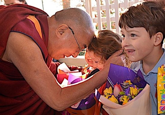 The Dalai Lama with children. Even though the Dalai Lama is very science-oriented, his priority clearly is Dharma, the teachings, and most especially compassion and love for all beings.