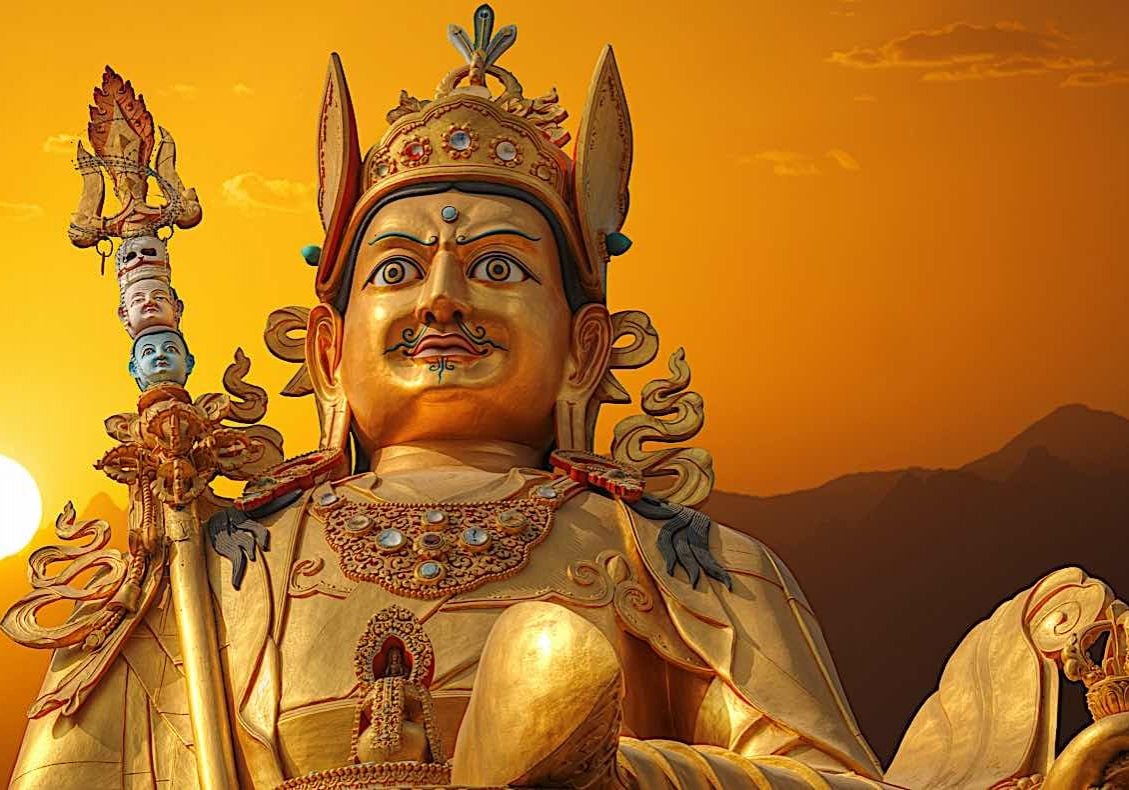 Outdoor statue of Guru Rinpoche Padmasambhava in Nepal at sunset.