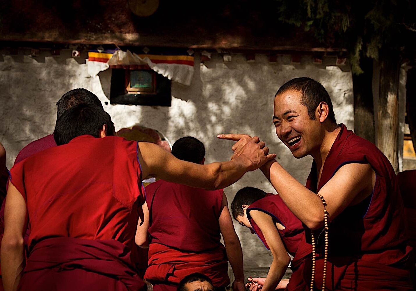 During a Dharma debate, monks laugh at each other's answers, here at Sera Jey Monestary.