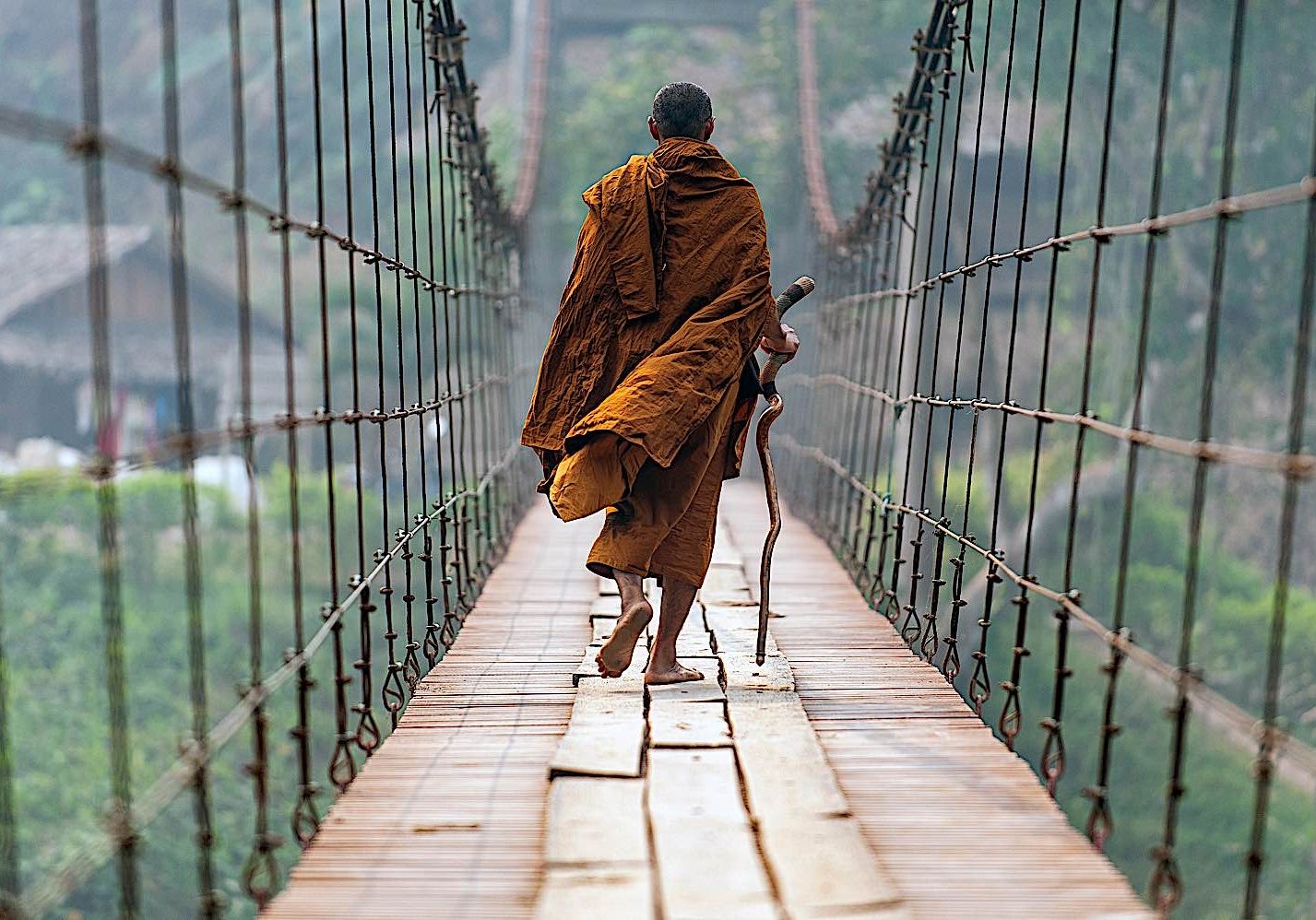 A Theravadan monk crossing a suspension bridge in mae Hong Son.